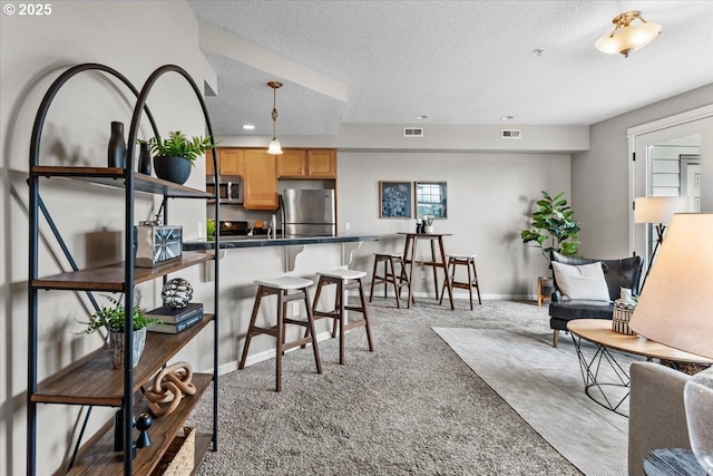 9183 NW Germantown Rd, Portland, OR 97231 - living area featuring a textured ceiling, light colored carpet, baseboards, and recessed lighting