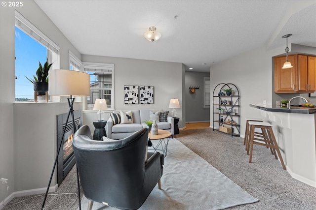 9183 NW Germantown Rd, Portland, OR 97231 - living room with light colored carpet, a glass covered fireplace, and baseboards
