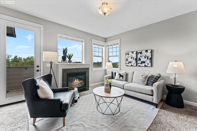 9183 NW Germantown Rd, Portland, OR 97231 - carpeted living room with baseboards, a high end fireplace, and a textured ceiling
