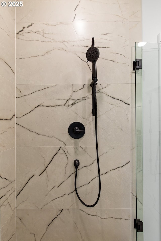 details featuring a marble finish shower