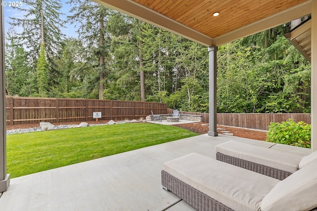 view of patio / terrace featuring an outdoor fire pit and a fenced backyard