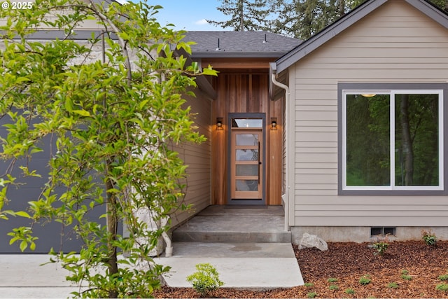 property entrance featuring roof with shingles
