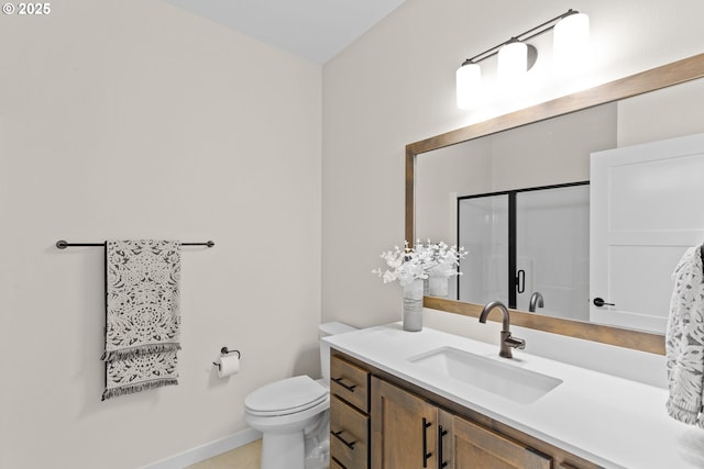 bathroom featuring vanity, baseboards, toilet, and a shower stall