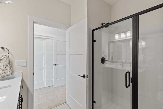 bathroom featuring a stall shower and vanity