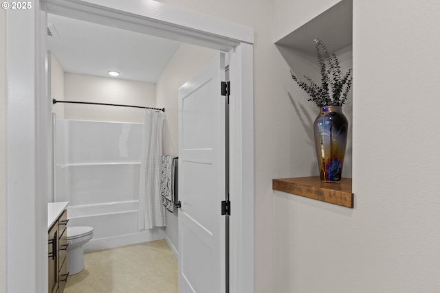 full bath featuring vanity, toilet, and shower / tub combo