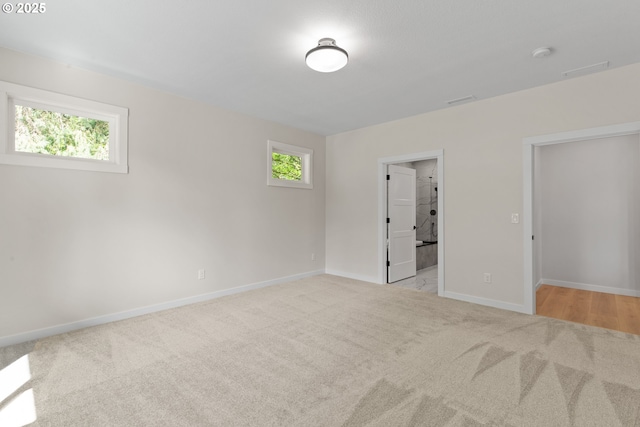 unfurnished bedroom featuring carpet, baseboards, and visible vents