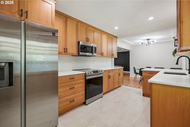 10559 NE Thompson St, Portland, OR 97220 - kitchen featuring stainless steel appliances, a sink, backsplash, recessed lighting, and light countertops