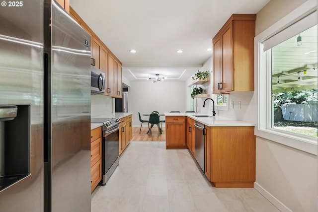 10559 NE Thompson St, Portland, OR 97220 - kitchen featuring stainless steel appliances, a sink, baseboards, recessed lighting, and light countertops