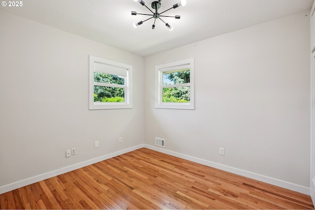 10559 NE Thompson St, Portland, OR 97220 - empty room with baseboards, a chandelier, and light wood finished floors