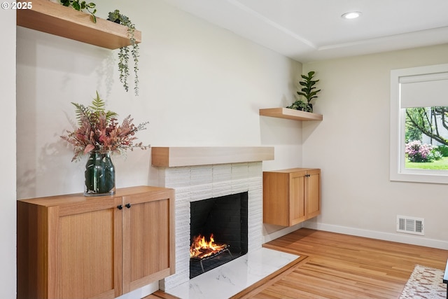10559 NE Thompson St, Portland, OR 97220 - living room featuring a brick fireplace, baseboards, light wood-style floors, and recessed lighting