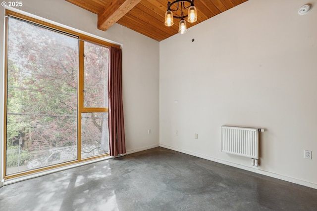 empty room with wood ceiling, concrete flooring, radiator, and baseboards