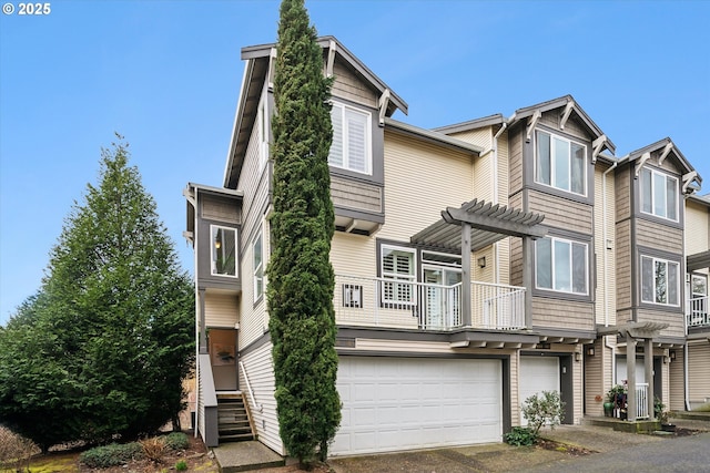 view of property with a garage, driveway, and a pergola