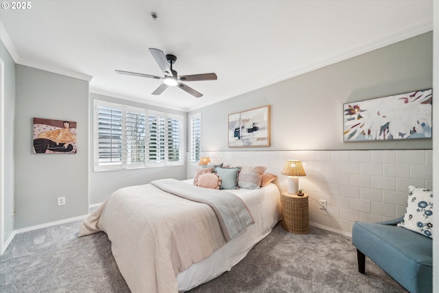 carpeted bedroom with baseboards, a ceiling fan, and crown molding