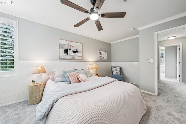 bedroom featuring carpet floors, a wainscoted wall, ornamental molding, and ceiling fan