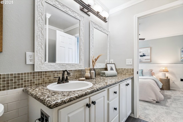 bathroom featuring vanity, ensuite bath, tile walls, and crown molding