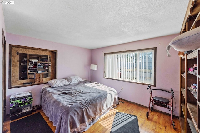 1366 Lakeshore Dr, Coos Bay, OR 97420 - bedroom featuring a textured ceiling, wood finished floors, and baseboards