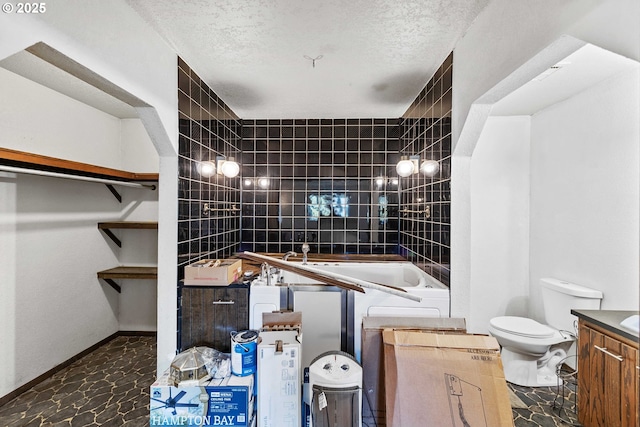 1366 Lakeshore Dr, Coos Bay, OR 97420 - bathroom featuring toilet, a tub to relax in, vanity, and a textured ceiling