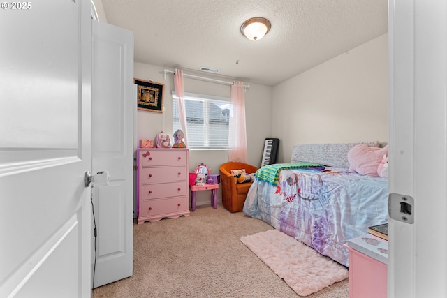 carpeted bedroom featuring a textured ceiling