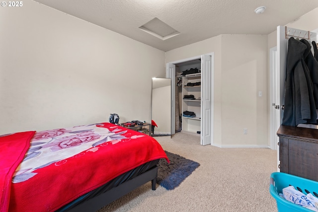 carpeted bedroom featuring a textured ceiling and a closet