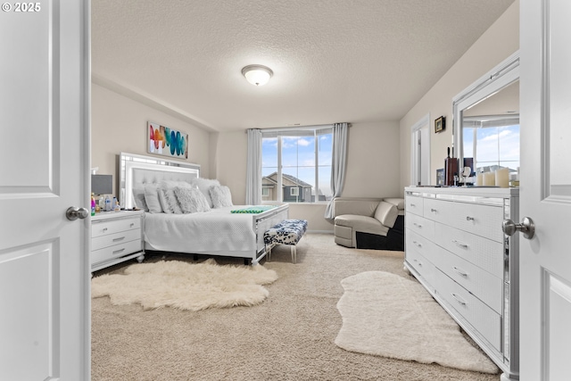 carpeted bedroom featuring a textured ceiling