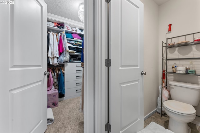 bathroom featuring toilet and a textured ceiling