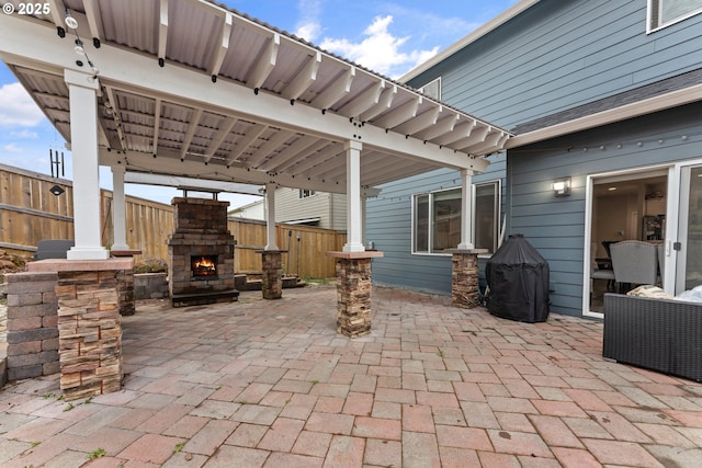 view of patio / terrace featuring an outdoor stone fireplace