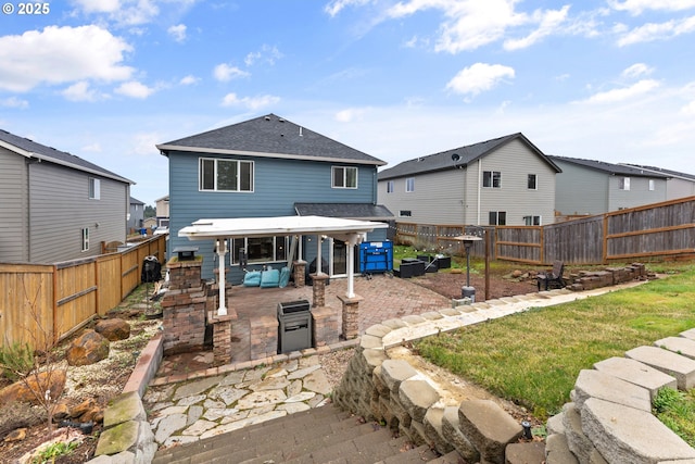 rear view of property featuring a lawn and a patio