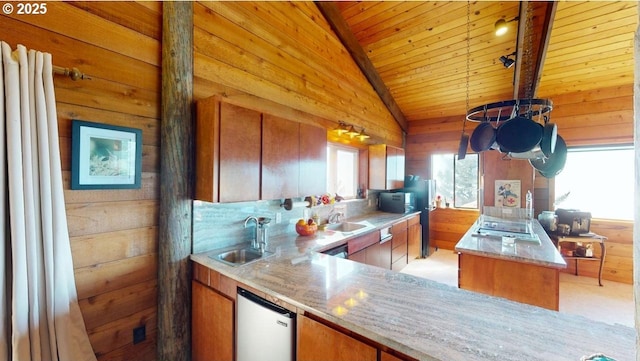 kitchen featuring lofted ceiling, wood ceiling, refrigerator, wood walls, and a sink