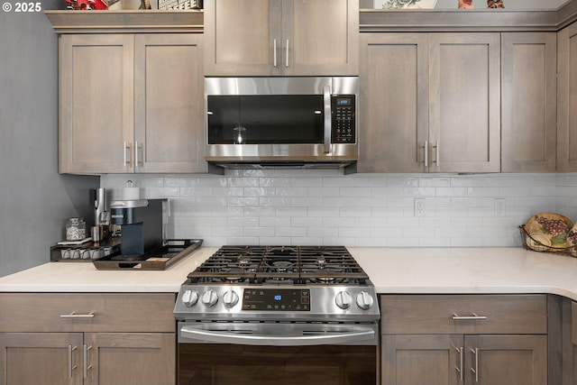 kitchen with backsplash and stainless steel appliances