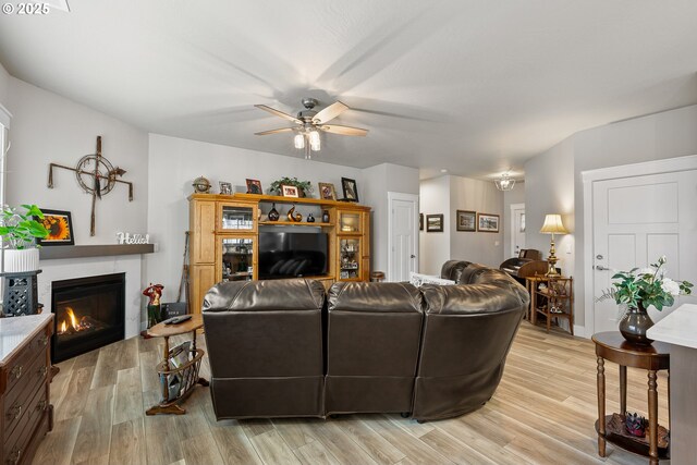 living room with ceiling fan and light wood-type flooring