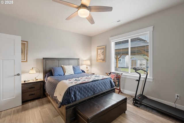 bedroom with light hardwood / wood-style flooring and ceiling fan