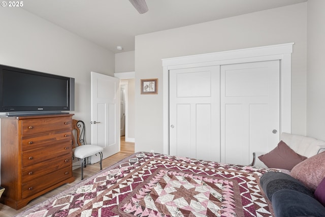 bedroom featuring a closet, ceiling fan, and light hardwood / wood-style flooring