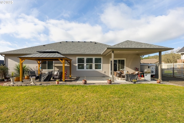 rear view of property featuring a patio area, a gazebo, and a yard