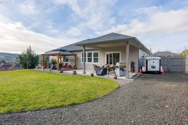 back of property featuring a patio area, a gazebo, and a lawn