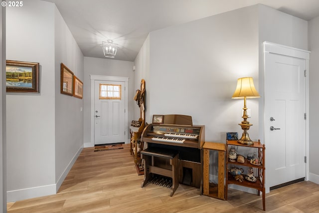 entryway with a chandelier and light hardwood / wood-style flooring