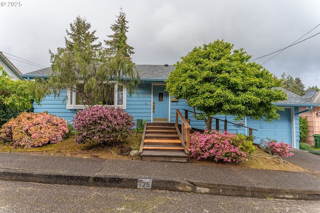 725 N 9th St, Coos Bay, OR 97420 - obstructed view of property with a garage and roof with shingles