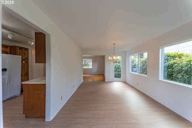 725 N 9th St, Coos Bay, OR 97420 - unfurnished dining area with a chandelier, light wood finished floors, track lighting, and baseboards
