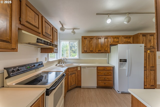 725 N 9th St, Coos Bay, OR 97420 - kitchen with white appliances, brown cabinetry, a sink, and track lighting