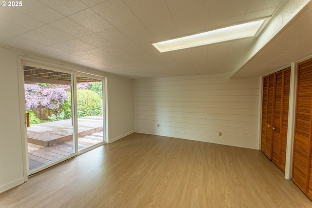 725 N 9th St, Coos Bay, OR 97420 - spare room featuring light wood-type flooring and wooden walls