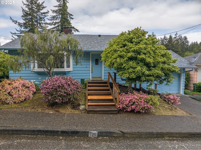 725 N 9th St, Coos Bay, OR 97420 - obstructed view of property with a shingled roof, a chimney, and a garage