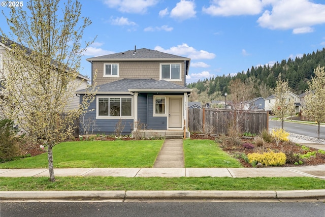 view of front of property with fence and a front lawn