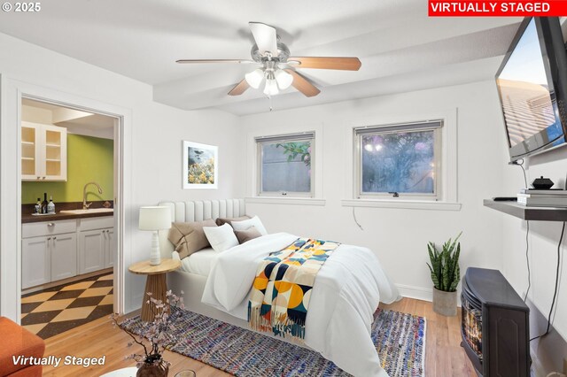 1529 SE Hawthorne Blvd Unit 2, Portland, OR 97214 - bedroom featuring light wood-style floors, ensuite bathroom, baseboards, and bar