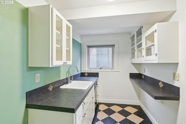 1529 SE Hawthorne Blvd Unit 2, Portland, OR 97214 - kitchen with a sink, dark floors, baseboards, white cabinets, and dark countertops
