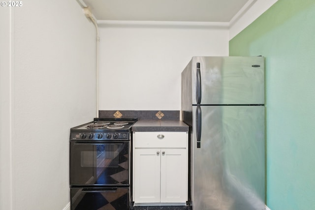 1529 SE Hawthorne Blvd Unit 2, Portland, OR 97214 - kitchen with freestanding refrigerator, electric range, white cabinets, and dark countertops