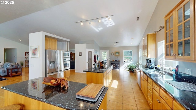 94342 Gauntlett St, Gold Beach, OR 97444 - kitchen with a center island, appliances with stainless steel finishes, lofted ceiling, track lighting, and dark stone countertops