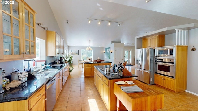 94342 Gauntlett St, Gold Beach, OR 97444 - kitchen featuring stainless steel appliances, a kitchen island, light tile patterned flooring, and glass insert cabinets