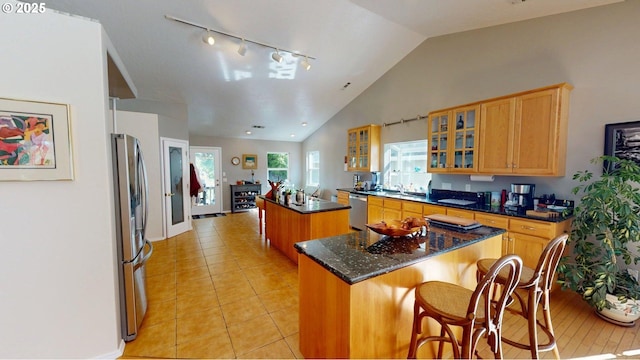 94342 Gauntlett St, Gold Beach, OR 97444 - kitchen featuring a center island, appliances with stainless steel finishes, lofted ceiling, glass insert cabinets, and light tile patterned floors