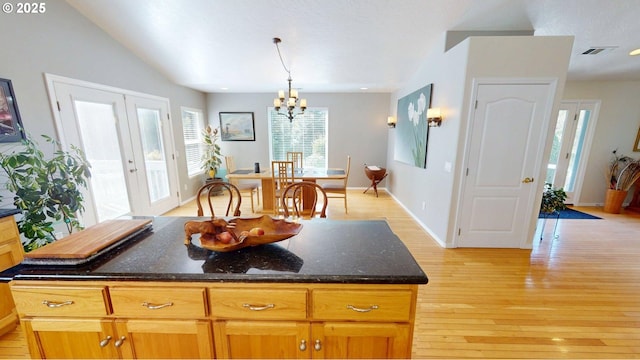 94342 Gauntlett St, Gold Beach, OR 97444 - kitchen featuring a chandelier, light wood-type flooring, healthy amount of natural light, and dark stone countertops