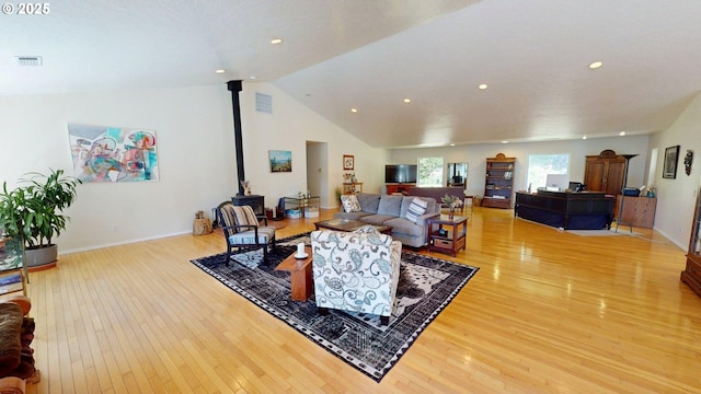 94342 Gauntlett St, Gold Beach, OR 97444 - living room featuring a wood stove, hardwood / wood-style floors, recessed lighting, and lofted ceiling