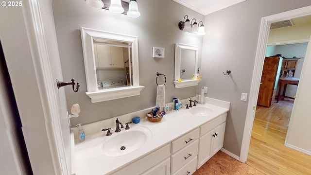 94342 Gauntlett St, Gold Beach, OR 97444 - bathroom with wood finished floors, double vanity, and crown molding